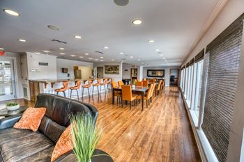A living room and dining room with a table and chairs